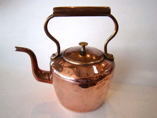 A nice small Victorian copper kettle with brass mounts circa 1840.